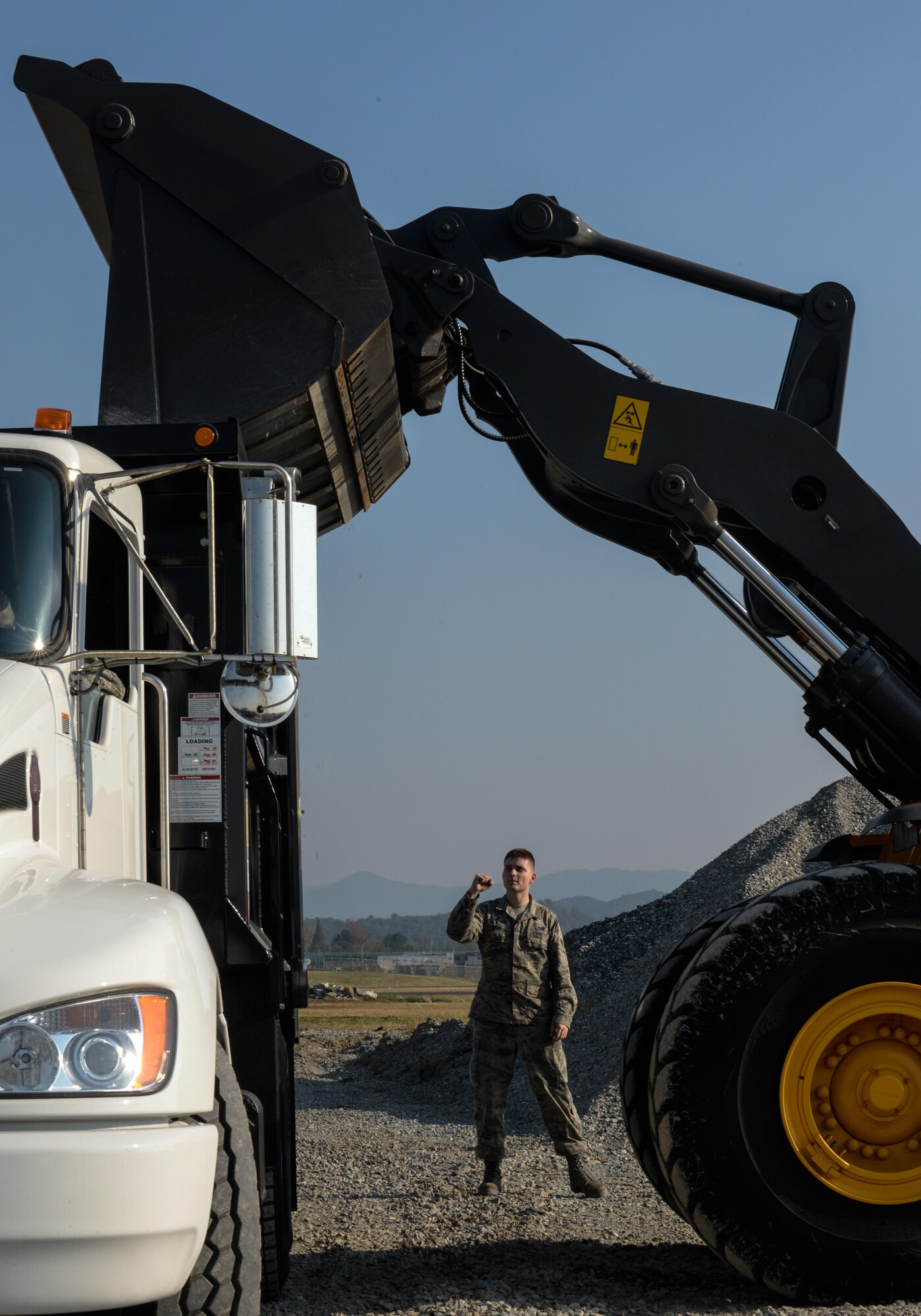 U.S. Air Force Airman 1st Class Charles Lucas provides guidance during a Rapid Airfield Damage Repair exercise at Gwangju Air Base, Republic of Korea, Nov. 6, 2017. Approximately forty U.S. Airmen from the 773d Civil Engineer Squadron at Joint Base Elmendorf-Richardson, Alaska, and 40 Republic of Korea Airmen from Gwangju trained together for a week to learn a new runway repair process for wartime contingencies. (U.S. Air Force photo by Senior Airman Curt Beach)