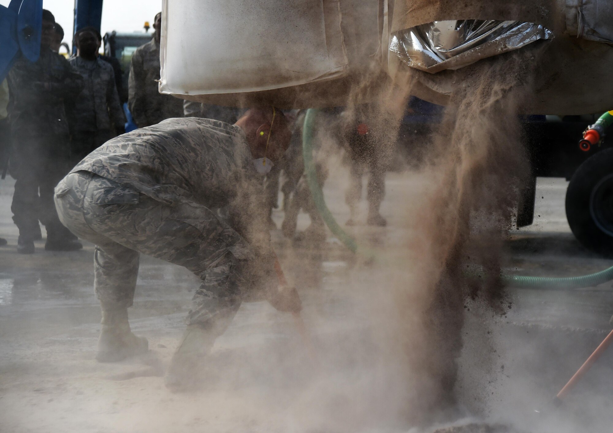 U.S. Air Force Tech. Sgt. Joseph Hamilton, Air Force Civil Engineer Center contingency instructor, spreads rapid-setting concrete during a Rapid Airfield Damage Repair training exercise at Gwangju Air Base, Republic of Korea, on Nov. 8, 2017. U.S. and R.O.K. Airmen trained together for a week to learn the new RADR process, preparing them for response to wartime contingencies, enhancing interoperability and building partnership capacity in the Indo-Asia Pacific region. (U.S. Air Force photo by Senior Airman Curt Beach)