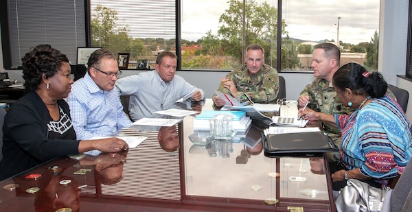 Col. John Hurley, center, commander of Huntsville Center, goes over the results of the Defense Equal Opportunity Management Institute Organizational Climate Survey with Angela Morton, right, supervisory equal opportunity officer with the center’s Equal Employment Opportunity Office, Oct. 23, 2017. Sitting with them at the table, from left to right, are Valerie Ward, human resources strategic adviser who managed the results of the Federal Employee Viewpoint Survey; Dan Heinzelman, business director; Albert “Chip” Marin III, programs director; and Lt. Col. Hugh Darville, deputy commander.
