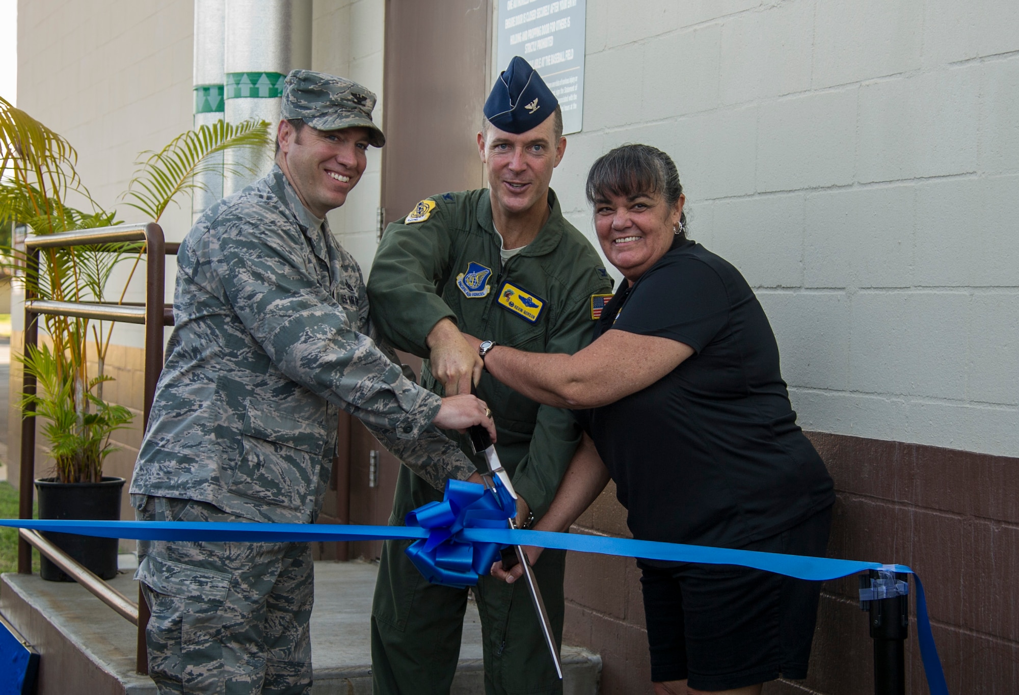 Col. Douglas Pierce, Joint Base Pearl Harbor-Hickam deputy commander, Col. Kevin Gordon, 15th Wing commander, and Dawn Pierce, Hickam Gym manager, cut a ribbon for the 24/7 opening of the Hickam Memorial Gym, Joint Base Pearl Harbor-Hickam, Hawaii, Nov. 20, 2017. The gym’s 24-hour access is available to all authorized users over the age of 18. Individuals who do not have a common access card may purchase a proximity card for a nominal fee. (U.S. Air Force photo by Tech. Sgt. Heather Redman)