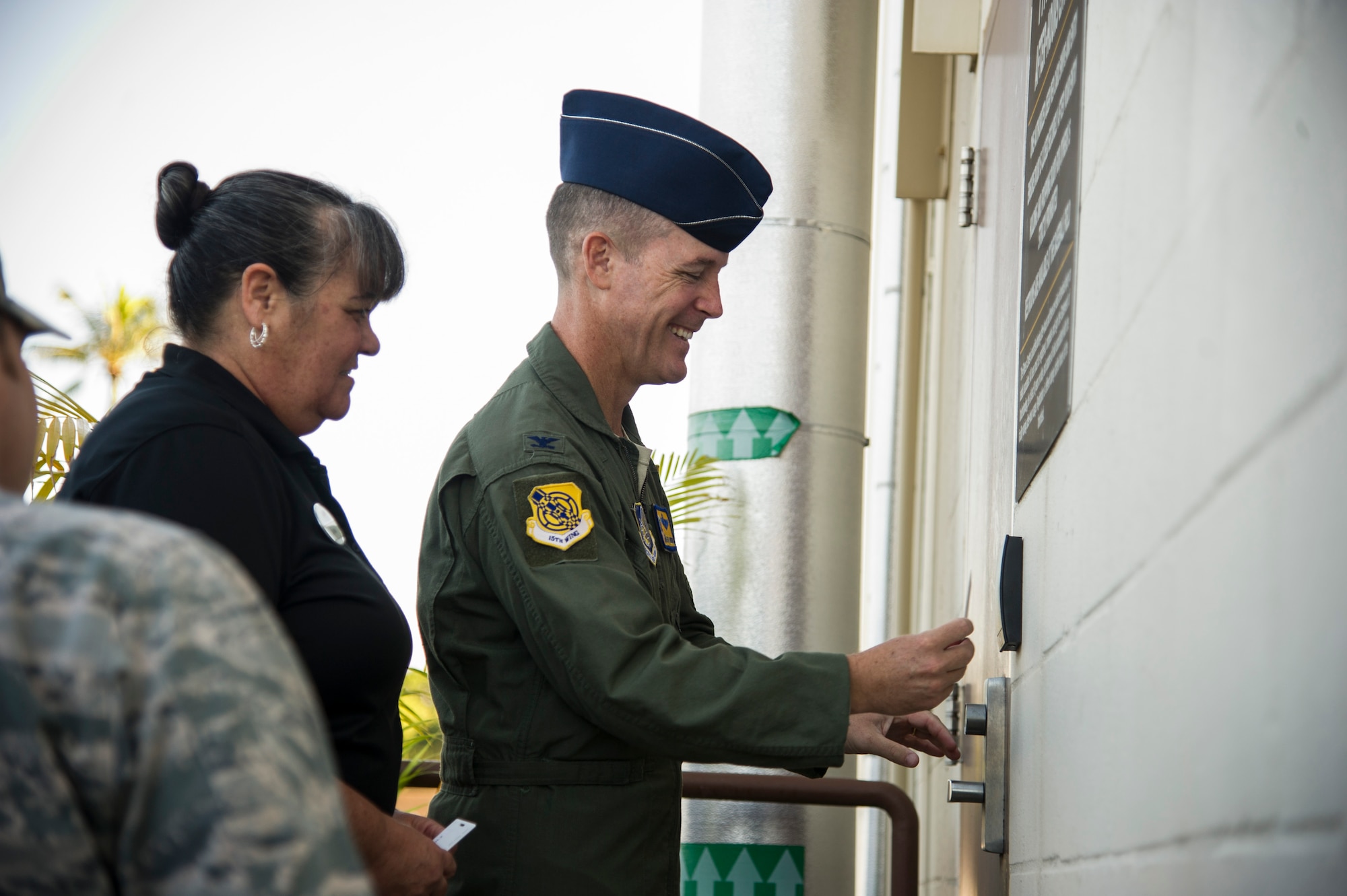 Col. Kevin Gordon, 15th Wing commander, and Dawn Pierce, Hickam Gym manager, use the 24/7 entry during the ribbon cutting of the Hickam Memorial Gym, Joint Base Pearl Harbor-Hickam, Hawaii, Nov. 20, 2017. The gym’s 24-hour access is available to all authorized users over the age of 18. Individuals who do not have a common access card may purchase a proximity card for a nominal fee. (U.S. Air Force photo by Tech. Sgt. Heather Redman)