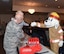 Sparky, the Fire Rescue mascot, fist bumps a child at the Warren Top 3 craft fair and health fair on F.E. Warren  Air Force Base Wyo., Nov. 17, 2017. Squadrons from all across the wing and members from the community set up booths to help promote health, safety or to just sell their crafts. (U.S. Air Force photo by Airman 1st Braydon Williams)