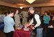 Robert Justice, a vender at the fair, demonstrates his health care products to visitors at the Warren Top 3 craft fair and health fair on F.E. Warren Air Force Base Wyo., Nov. 17, 2017. Justice, crafts and packages each bar of shaving soap he sells by hand. (U.S. Air Force photo by Airman 1st Braydon Williams)