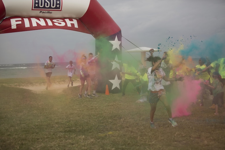 TORII STATION, OKINAWA, Japan – Participants of the 5th Annual USO Okinawa Color Blast 5K Fun Run are blasted with color as they cross the finish line Nov. 18 on Torii Station Beach, Okinawa, Japan.