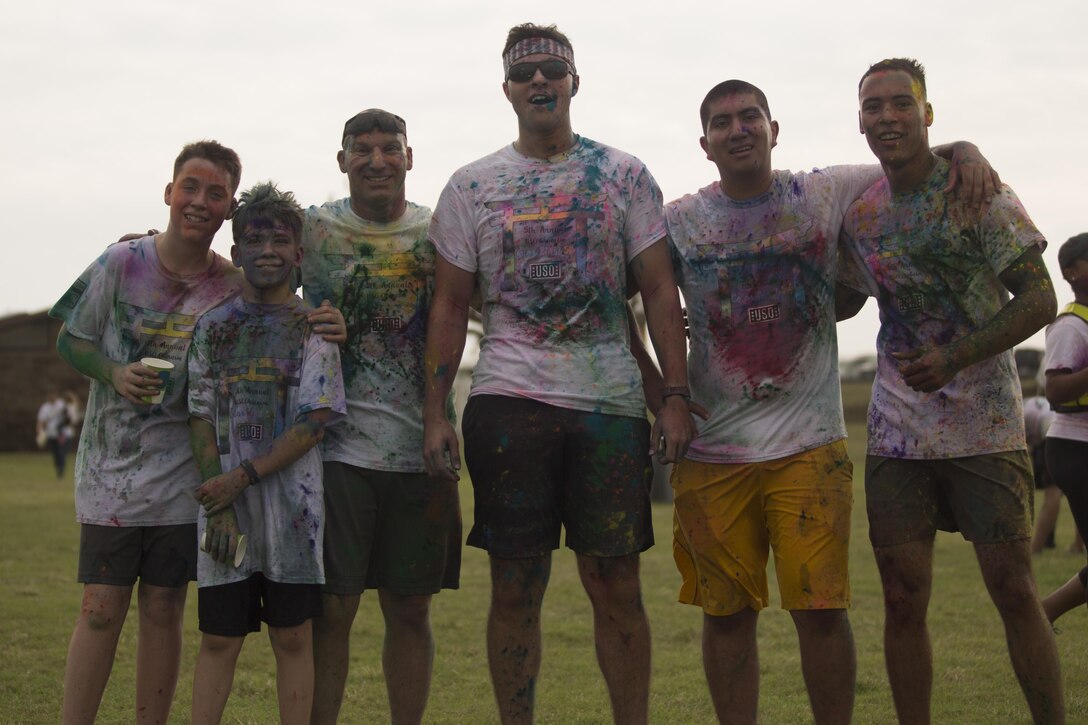 TORII STATION, OKINAWA, Japan – Participants of the 5th Annual USO Okinawa Color Blast 5K Fun Run pose for a picture after finishing the run Nov. 18 on Torii Station Beach, Okinawa, Japan.