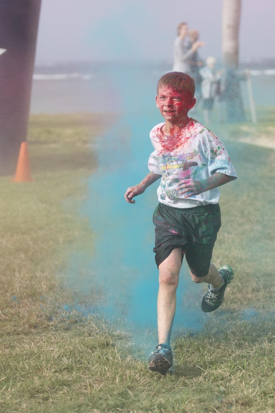 TORII STATION, OKINAWA, Japan – A child finishes the 5th Annual USO Okinawa Color Blast 5K Fun Run Nov. 18 on Torii Station Beach, Okinawa, Japan.