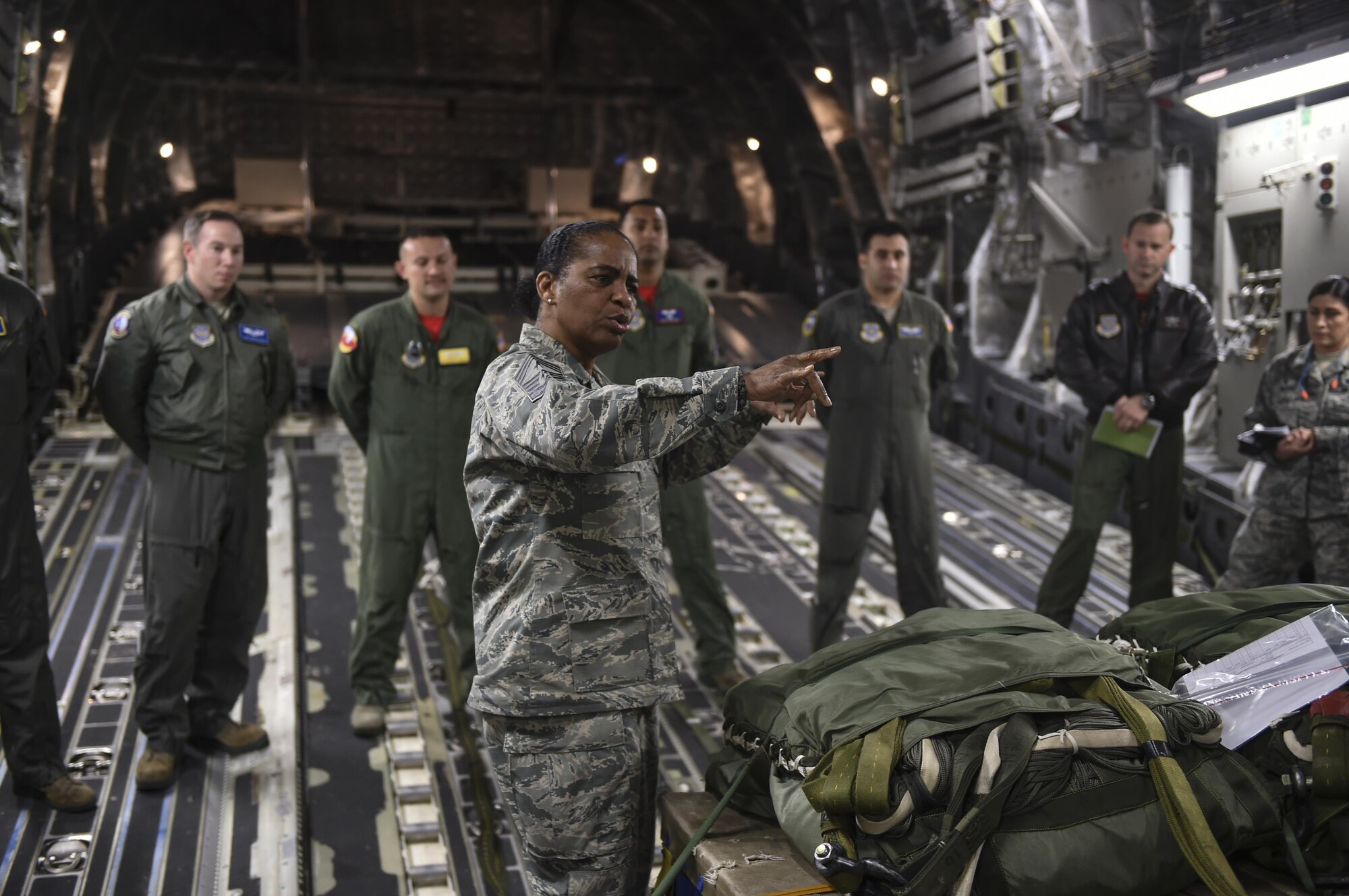 Chief Master Sgt. Shelina Frey, Air Mobility Command command chief, explains to aircrew members of the 15th and 16th Airlift Squadron about how important their feedback is to help the AMC mission while aboard a C-17 Globemaster III on the flightline at Joint Base Charleston, S.C., Nov. 17, 2017.