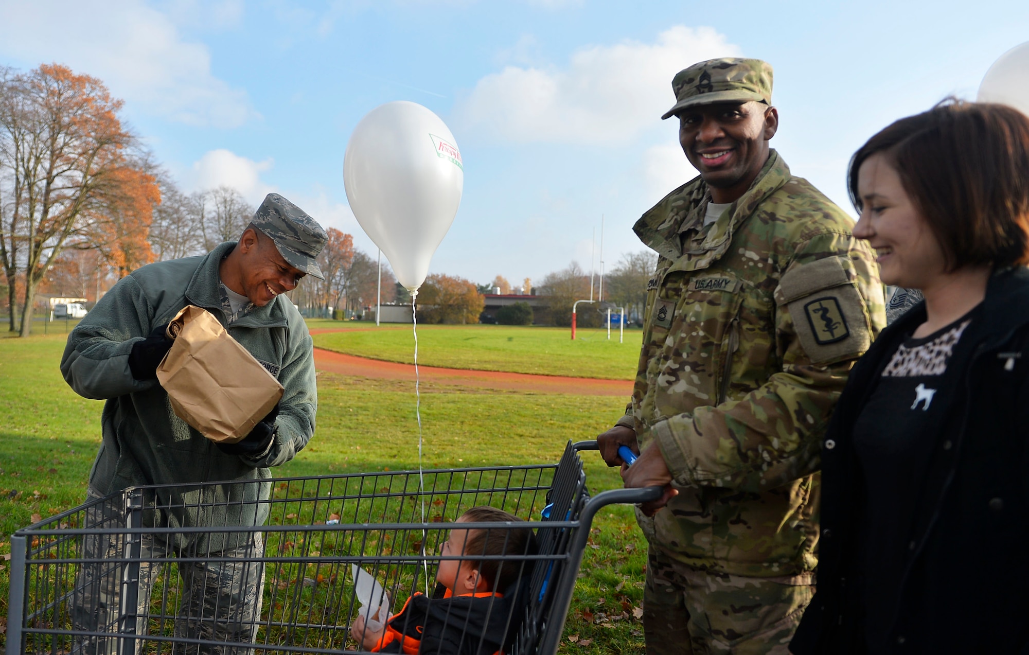 U.S. Air Force Chief Master Sgt. Jackie Harris, 24th Intelligence Squadron superintendent, left, loads a Thanksgiving package into a cart during an event sponsored by the United Services Organization on Vogelweh Military Complex, Germany, Nov. 18, 2017.  Senior enlisted leaders from multiple organizations in the Kaiserslautern Military Community teamed up with the USO to provide military members, pay grade E-5 and below, with Thanksgiving meals. (U.S. Air Force photo by Airman 1st Class Joshua Magbanua)