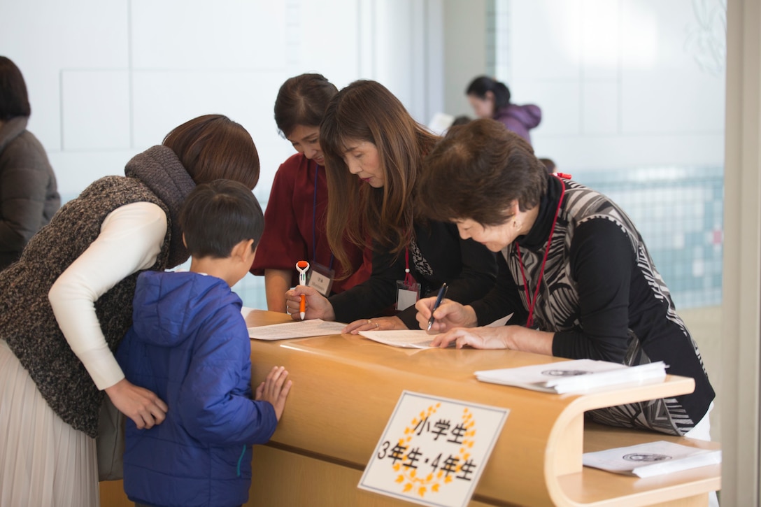 Contestants and visitors register for the 56th Annual Japanese and English Speech Contest at Sinfonia Iwakuni Concert Hall in Iwakuni City, Japan, Nov. 19, 2017.  The contest was hosted by the Japanese American Society to help contestants understand and appreciate each other’s language and culture, strengthening the Japanese and American friendship.