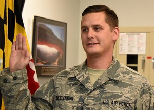 Senior Airman Michael McClenning re-enlists with Maryland Air National Guard Nov. 20, 2017 at Warfield Air National Guard Base, Middle River, Md. McClening is a full time Fuels Distribution Technician and has been a member of the guard since 2012. (U.S. Air National Guard photo by Senior Airman Enjoli Saunders)