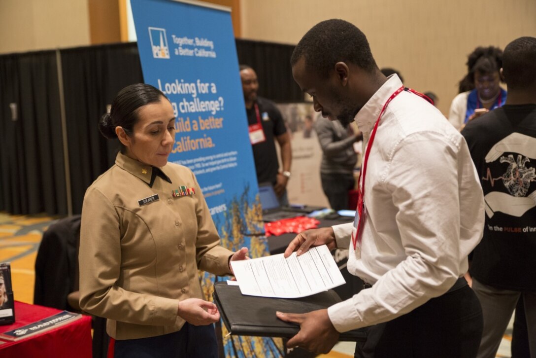 U.S. Marine Corps Maj. Jessica Shearer, Communication Officer, 4th Medical Battalion, 4th Marine Logistics Group, interviews students at the National Society of Black Engineers Symposium in Garden Grove, Calif., November 18, 2017. During the symposium Marines interact with collegiate-level students from across the country whom have shown outstanding qualities in education and leadership. By investing in a diverse and representative officer corps, it will help generate and sustain a future force that has the cultural expertise, language skills, and a variety of philosophies needed to meet the operational requirements of the Marine Corps. (U.S. Marine Corps photo by Lance Cpl. Jesus McCloud/Released)