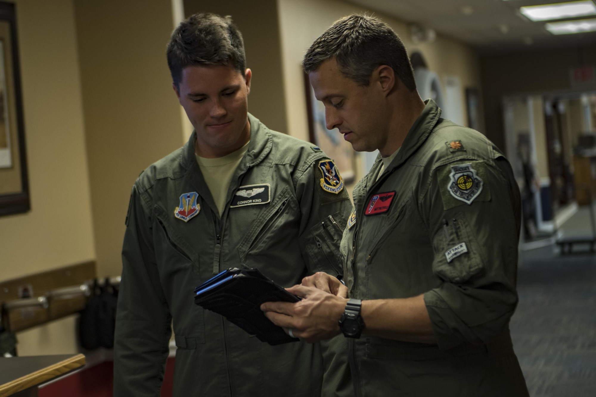 U.S. Air Force Reserve Maj. Matt Paetzhold, 76th Fighter Squadron A-10C Thunderbolt II instructor pilot, talks with 1st Lt. Connor King, 75th Fighter Squadron pilot, Sept. 9, 2017, at Moody Air Force Base, Ga. After graduating the Weapons Instructor Course, Paetzhold joined the Airmen who serve as tactical and operational advisors to military leaders at all levels. Due to the relationship between the 75th FS and 76th FS, Paetzhold is slated to deploy as the 75th FSs weapons officer. (U.S. Air Force photo by Senior Airman Daniel Snider)