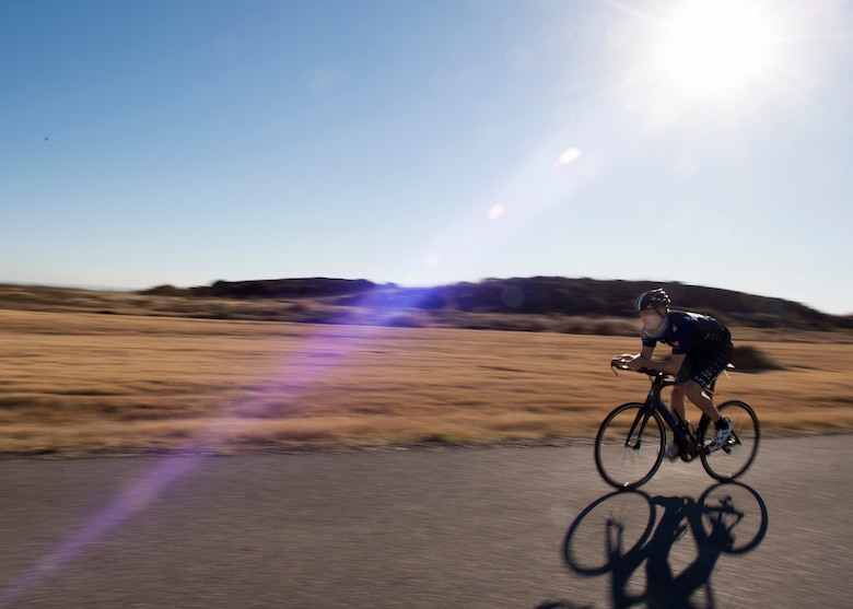 U.S. Air Force Capt. John Lachiewicz, an evaluation pilot with the 54th Air Refueling Squadron, rides his bike on Perimeter Road, Nov. 15, 2017, at Altus Air Force Base, Oklahoma.