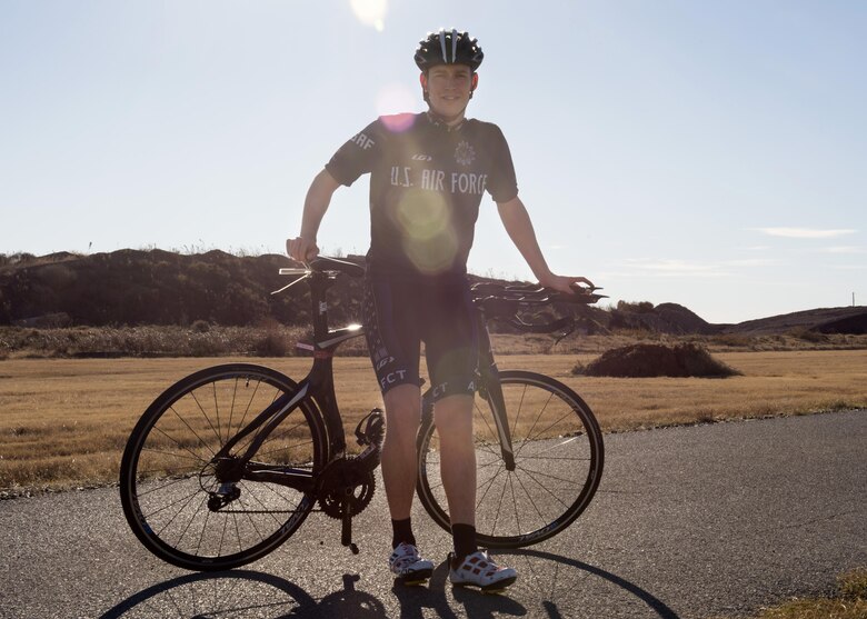 U.S. Air Force Capt. John Lachiewicz, an evaluation pilot with the 54th Air Refueling Squadron, poses for a portrait with his bike, Nov. 15, 2017, at Altus Air Force Base, Oklahoma.