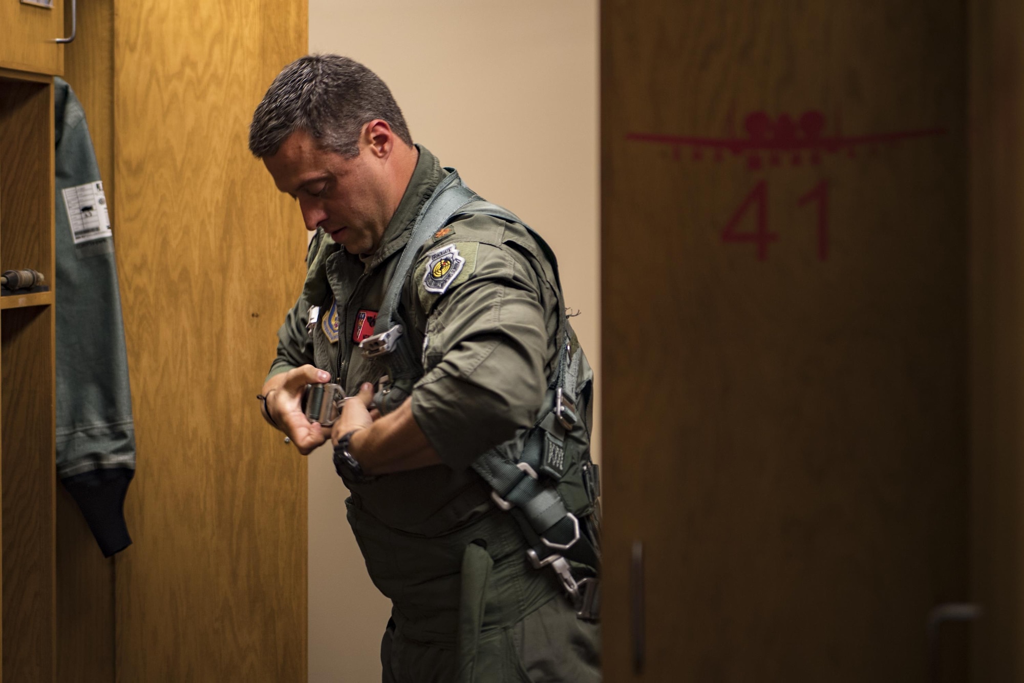 U.S. Air Force Maj. Matt Paetzhold, 76th Fighter Squadron A-10C Thunderbolt II instructor pilot dons equipment before flight, Sept. 9, 2017, at Moody Air Force Base, Ga. After graduating the Weapons Instructor Course, Paetzhold joined the Airmen who serve as tactical and operational advisors to military leaders at all levels. Due to the relationship between the 75th FS and 76th FS, Paetzhold is slated to deploy as the 75th FSs weapons officer. (U.S. Air Force photo by Senior Airman Daniel Snider)
