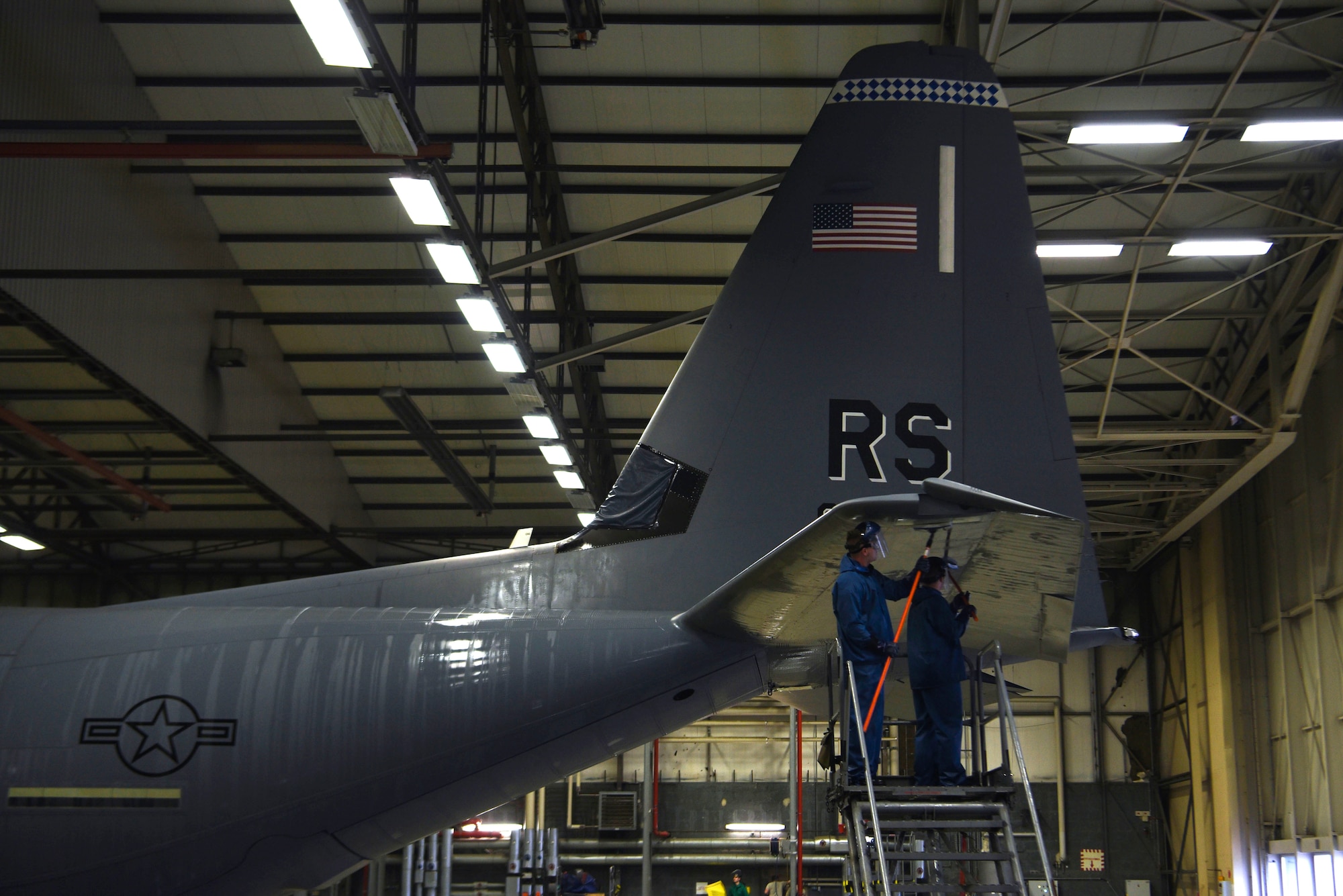 U.S. Air Force Airmen 1st Class Kaleb Lemons, and Kane McKinnon, both C-130J Super Hercules crew chiefs, clean the tail section of a C-130J on Ramstein Air Base, Germany, Nov. 20, 2017. Crew chiefs clean aircraft before every major inspection. (U.S. Air Force photo by Airman 1st Class Devin M. Rumbaugh)
