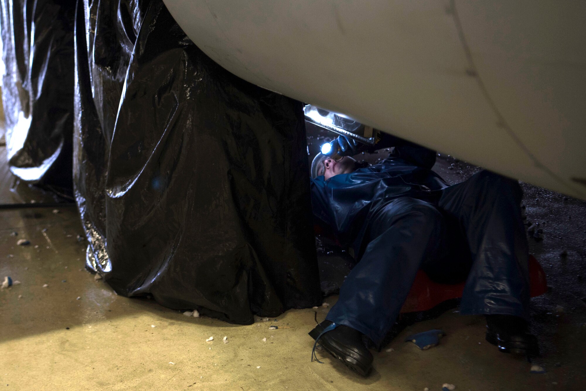 U.S. Air Force Senior Airman Joshua Lindsley, C-130J Super Hercules crew chief, cleans the inside of a wheel underneath a C-130J on Ramstein Air Base, Germany, Nov. 20, 2017. It takes maintainers manning two,12-hour shifts to fully clean the aircraft. (U.S. Air Force photo by Airman 1st Class Devin M. Rumbaugh)