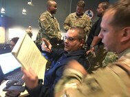 Chris Sabo, Geospatial Information Systems technician, Joint Task Force Civil Support, speaks with a member of the Defense CBRN Response Force during a Mobile Training Team event at Fort Bragg, N.C. November 14, 2017.JTF-CS provides command and control for designated Department of Defense specialized response forces to assist local, state, federal and tribal partners in saving lives, preventing further injury, and providing critical support to enable community recovery. (Official DOD Photo MC2 Benjamin Liston)