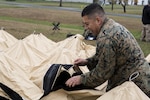 Staff Sgt. Hector Ochoa, non-commissioned officer in charge, current operations, JTF-CS sets up a DRASH tent at Ft. A.P. Hill, Virginia during a communications exercise. JTF-CS provides command and control for designated Department of Defense specialized response forces to assist local, state, federal and tribal partners in saving lives, preventing further injury, and providing critical support to enable community recovery. (Official DOD Photo MC2 Benjamin Liston)