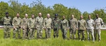 Members of the Combined Joint Task Force - Horn of Africa, Kentucky National Guard, Djibouti Armed Forces (FAD), and French army pose for a group photo during a visit to the FAD military training center at Holhol, Djibouti, Nov. 14, 2017.