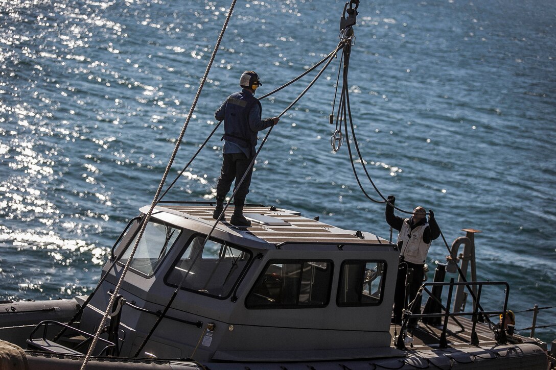 U.S. Sailors assigned to the dock landing ship USS Oak Hill (LSD 51) prepare a safety boat to be used during the transition from shore to ship of the Amphibious Assault Vehicle Platoon with Fox Company, Battalion Landing Team, 2nd Battalion, 6th Marine Regiment, 26th Marine Expeditionary Unit (MEU), near Onslow Beach, N.C., Nov. 17, 2017, as part of Combined Composite Training Unit Exercise ( COMPTUEX). Combined COMPTUEX serves as the capstone event for the Amphibious Ready Group-MEU team prior to a deployment, fully integrating the ARG-MEU team as an amphibious force and testing their ability to execute missions across a range of military operations. (U.S. Marine Corps photo by Staff Sgt. Dengrier M. Baez)
