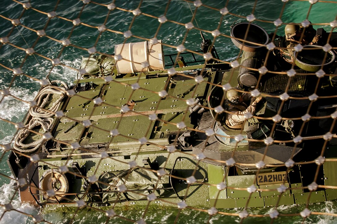 A U.S. Marine Corps AAV-P7/A1 assault amphibious vehicle (AAV) with AAV Platoon, Fox Company, Battalion Landing Team, 2nd Battalion, 6th Marine Regiment, 26th Marine Expeditionary Unit (MEU), is driven into the dock landing ship USS Oak Hill (LSD 51) during a transition of the AAVs from shore to ship near Onslow Beach, N.C., Nov. 17, 2017, as part of Combined Composite Training Unit Exercise ( COMPTUEX). Combined COMPTUEX serves as the capstone event for the Amphibious Ready Group-MEU team prior to a deployment, fully integrating the ARG-MEU team as an amphibious force and testing their ability to execute missions across a range of military operations. (U.S. Marine Corps photo by Staff Sgt. Dengrier M. Baez)