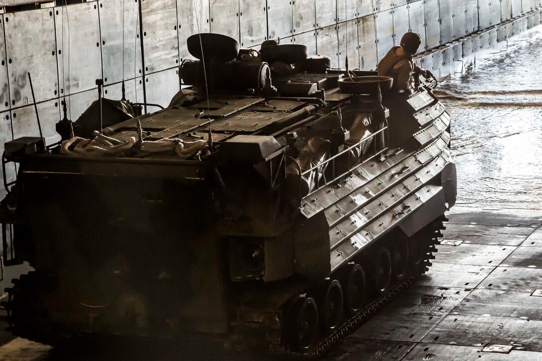 A U.S. Marine with the Assault Amphibious Vehicle (AAV) Platoon assigned to Fox Company, Battalion Landing Team, 2nd Battalion, 6th Marine Regiment, 26th Marine Expeditionary Unit (MEU), drives the vehicle into position at the well deck of the dock landing ship USS Oak Hill (LSD 51) in preparation to conduct a night  mechanized raid at Camp Lejeune, N.C., as part of Combined Composite Training Unit Exercise (COMPTUEX), Nov. 18, 2017. Combined COMPTUEX serves as the capstone event for the Amphibious Ready Group (ARG)/MEU team prior to deployment, fully integrating the ARG/MEU team as an amphibious force and testing their ability to execute missions across a range of military operations.