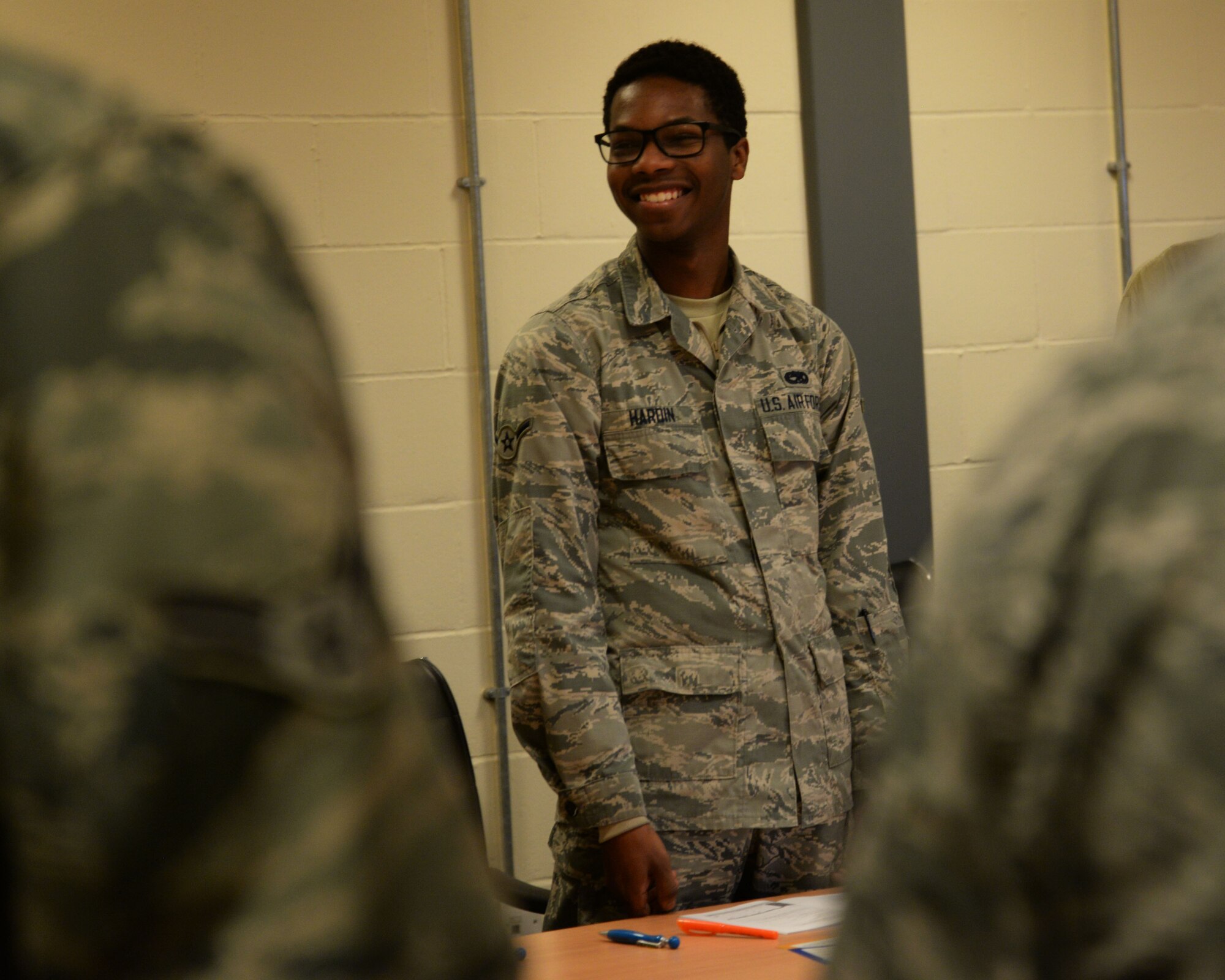 U.S. Air Force Airman Terrance Hardin, 100th Maintenance Squadron aircraft structural maintenance journeyman laughs during a name game ice breaker before the training exercises at RAF Mildenhall, England, Oct. 24, 2017. Members from the 100th Maintenance Squadron participated in the Four Lenses training, hosted by the Equal Opportunity office. The training focuses on learning how to work together despite personality differences. (U.S. Air Force photo by Airman 1st Class Alexandria Lee)