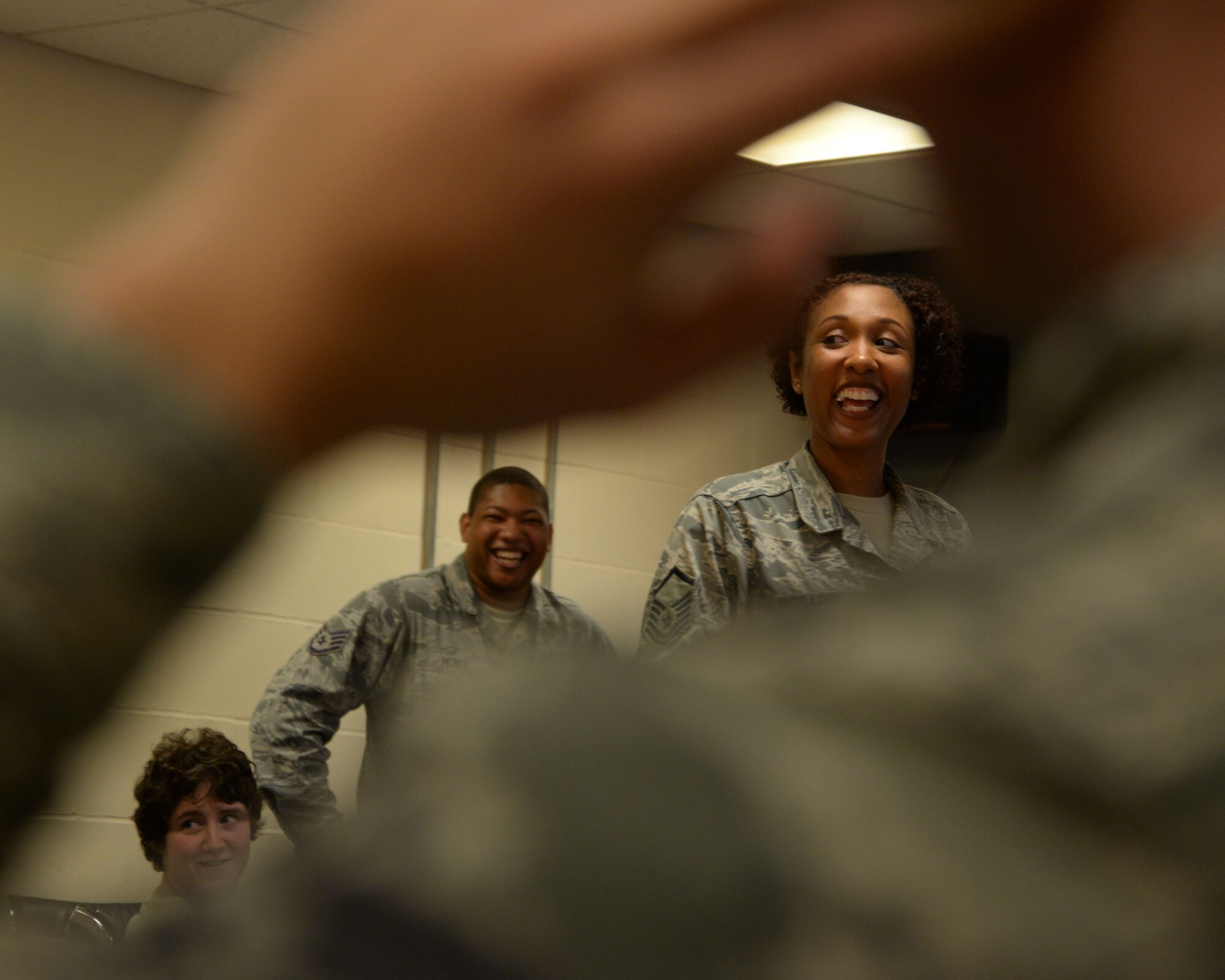 U.S Air Force Master Sgt. Shanique Rosario, 100th Air Refueling Wing Equal Opportunity office director, laughs during a discussion explaining the colors of the Four Lenses training exercise at RAF Mildenhall, England, Oct. 24, 2017. The training helps bring teams together by creating a basic understanding of each other’s personality traits. The Equal Opportunity office offers training and resolution skills to active-duty members as well as civilians. (U.S. Air Force photo by Airman 1st Class Alexandria Lee)