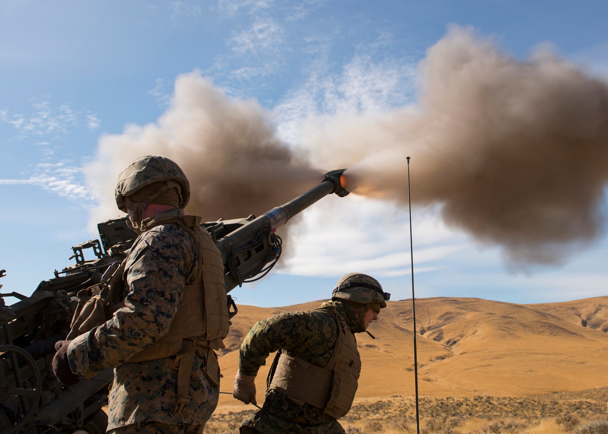 Marines of P Battery 5/14 fire a high explosive projectile downrange from a M777A2 howitzer weapon system during a live-fire training exercise at the Yakima Training Center, Washington, Oct 14, 2017. USMC crews can fire an M777A2 howitzer up to five rounds a minute under intense firing conditions and can provide a sustained rate of fire of two rounds a minute. (U.S. Air Force photo/Senior Airman Ryan Lackey)