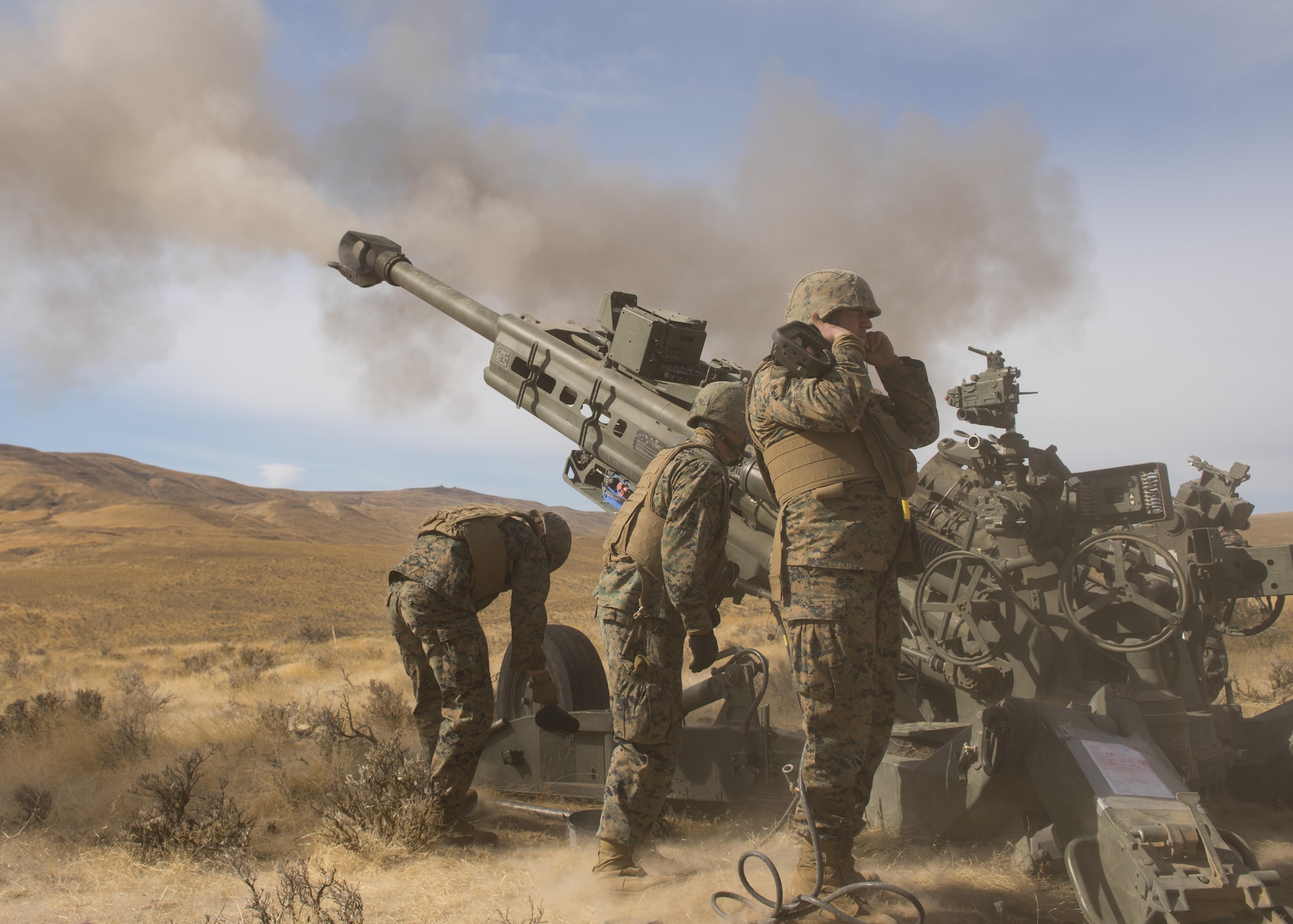 Marines of P Battery 5/14 fire a high explosive projectile downrange from a M777A2 howitzer weapon system during a live-fire training exercise at the Yakima Training Center, Washington, Oct 14, 2017. The muzzle brake located at the end of a M777A2 howitzer barrel, takes the energy of the extra propellant gases when fired and redirects it backwards into the ground, slowing the recoil and preventing the weapon from bouncing. (U.S. Air Force photo/Senior Airman Ryan Lackey)