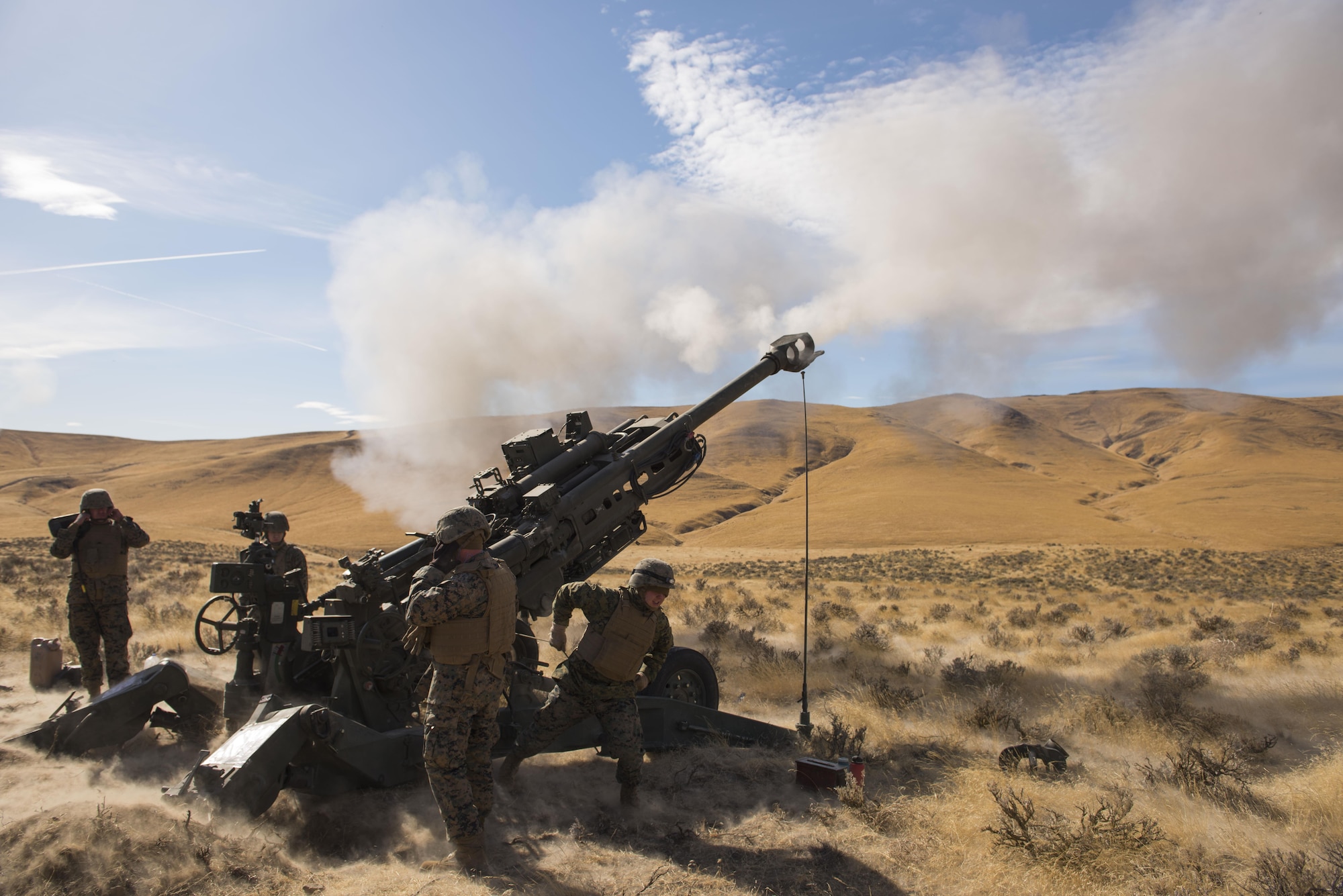 Marines of P Battery 5/14 fire a high explosive projectile downrange from a M777A2 howitzer weapon system during a live-fire training exercise at the Yakima Training Center, Washington, Oct 14, 2017. USMC artillery units mission is to provide long range fire support to infantry ground forces down-range in a deployed environment. (U.S. Air Force photo/Senior Airman Ryan Lackey)