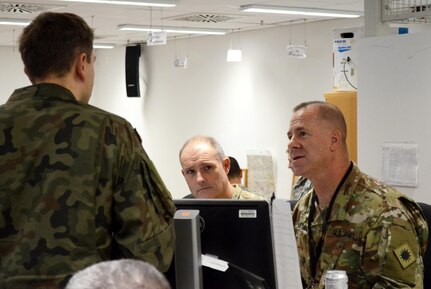 U.S. Army Brig. Gen. Jeffrey Smiley (RT), Commanding General of the 40th Infantry Division, California Army National Guard, discusses the situational battlefield during the daily command update brief during exercise Allied Spirit VII at the U.S. Army's Joint Multinational Readiness Center in Hohenfels, Germany Nov. 17, 2017.