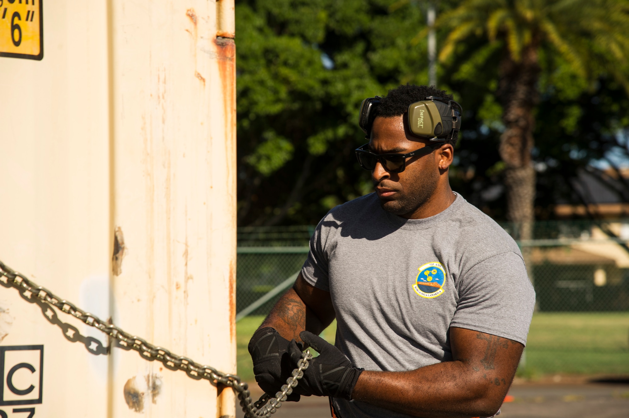 Staff Sgt. Byron Patrick, 735th Air Mobility Squadron reserve coordinator, secures a shipping container for the pallet build-up competition during the Hickam Port Dawg Challenge, at Joint Base Pearl Harbor-Hickam, Hawaii, Nov. 17, 2017. The aerial port community hosts a Port Dawg Challenge every year to promote professionalism, and demonstrate air and space expeditionary force capabilities. (U.S. Air Force photo by Tech. Sgt. Heather Redman)
