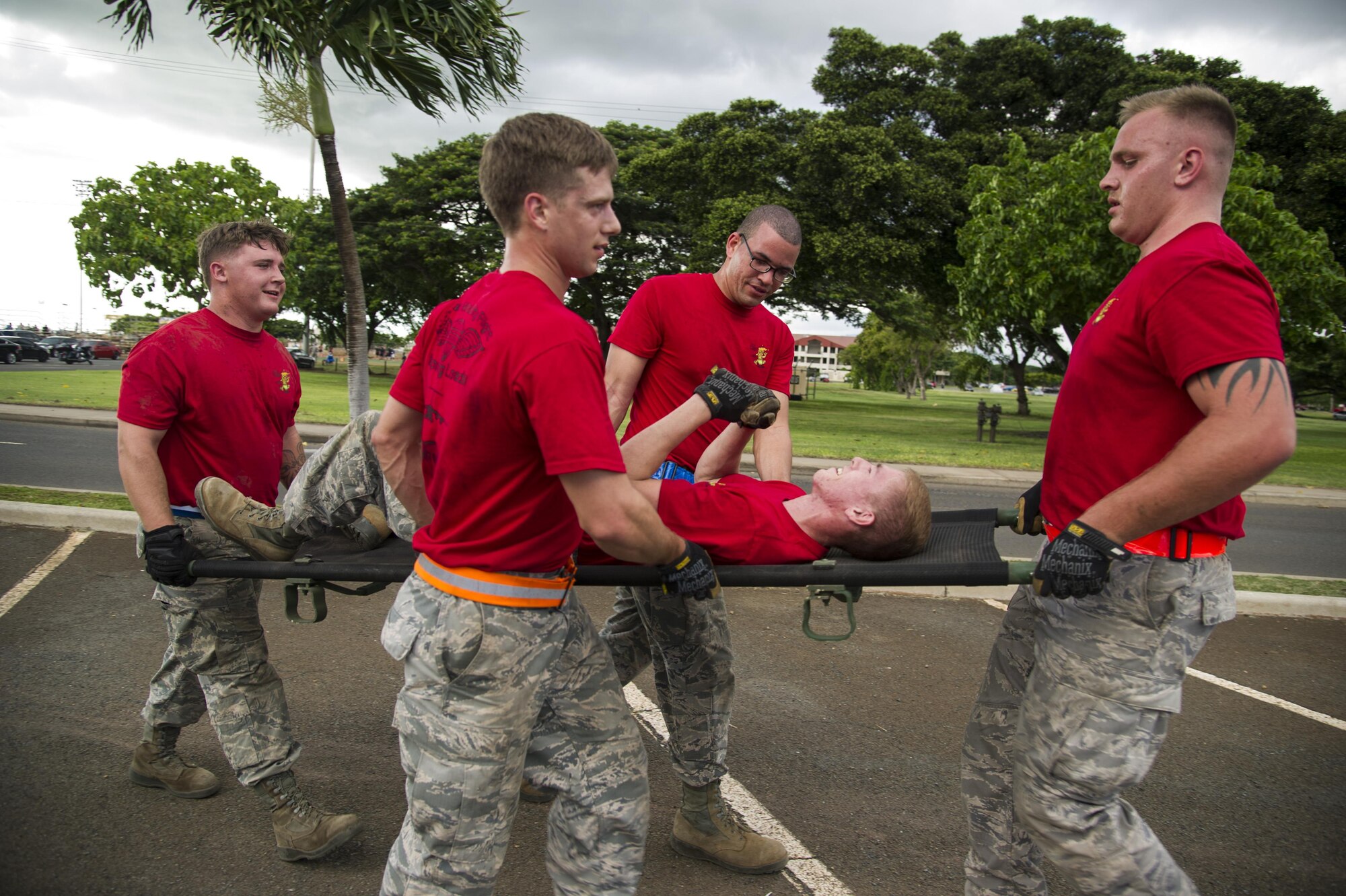 Service members from the 647th Logistics Readiness Squadron combat mobility flight perform a litter carry during the combat fitness challenge portion of the Hickam Port Dawg Challenge, at Joint Base Pearl Harbor-Hickam, Hawaii, Nov. 17, 2017. The aerial port community hosts a Port Dawg Challenge every year to promote professionalism, and demonstrate air and space expeditionary force capabilities. (U.S. Air Force photo by Tech. Sgt. Heather Redman)