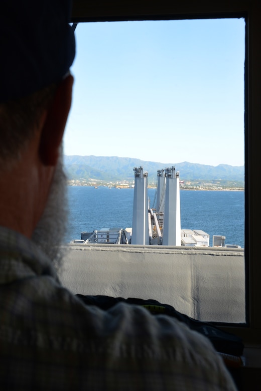 Alfred Murray, Military Sealift Command’s USNS Brittin captain, peers out over the bridge of the vessel upon arrival to Port of Ponce, Puerto Rico, Nov. 3, 2017.