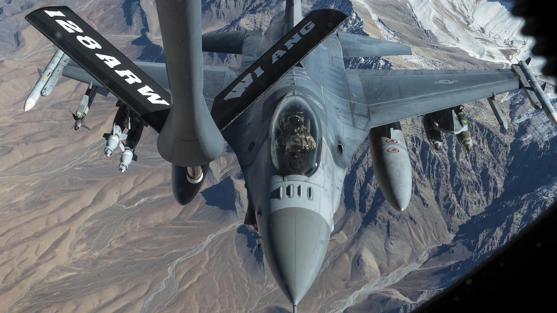 An F-16 aircraft prepares to receive fuel in flight from another aircraft.