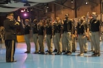 Army Chief of Staff Gen. Mark A. Milley administers the oath of enlistment to 35 young men and women who will join the ranks of the Army, the Army Reserve and the Army National Guard during the 242nd Army Birthday Twilight Tattoo at Conmy Hall, Joint Base Myer-Henderson Hall, Va., June 14, 2017.