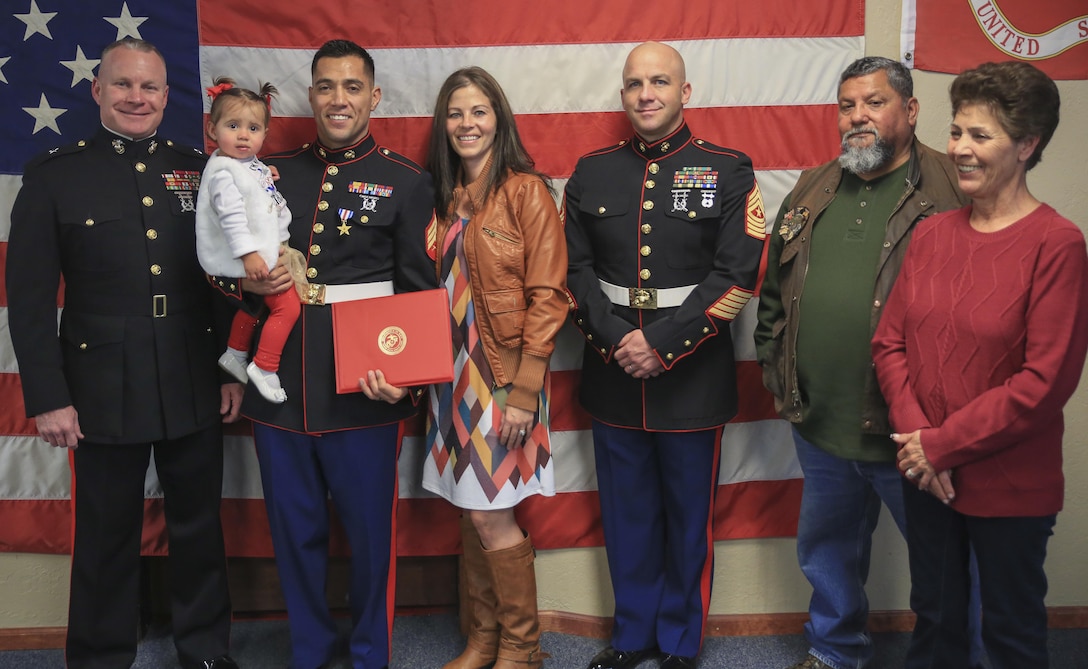 Brig Gen. Michael Martin (far left), deputy commanding general of Marine Corps Forces Command, Sgt. Eubaldo Lovato, Silver Star recipient, and Sgt. Maj. Bryan Fuller, Combat Logistics Group 453 Sgt. Maj., pose for a photo with Lovato’s family in Montrose, Colo., Nov. 18, 2017. Lovato received an award upgrade, from his previous Bronze Star, for his heroic actions while serving as a squad leader with Company A, 1st Battalion, 8th Marine Regiment, 1st Marine Division, during Operation Al Fajr, part of Operation Iraqi Freedom, on Nov. 15, 2004. The Silver Star is the United States third-highest personal decoration for valor in combat.