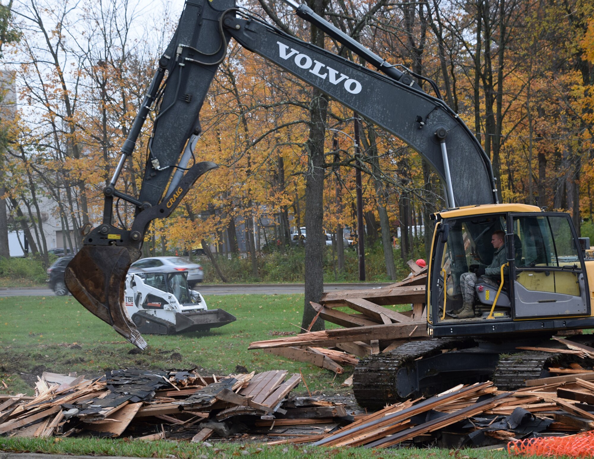 WRIGHT-PATTERSON AIR FORCE BASE, Ohio – Senior Airman Jarrod Harvey, 200th RED HORSE Detachment 1 heavy equipment operator, operates an excavator during the demolition of a condemned pavilion at the Air Force Institute of Technology Nov. 17, 2017. Ten RED HORSE Airmen participated in the demolition and are scheduled to return next spring to begin construction on a new pavilion. (U.S. Air Force photo/Katie Scott)