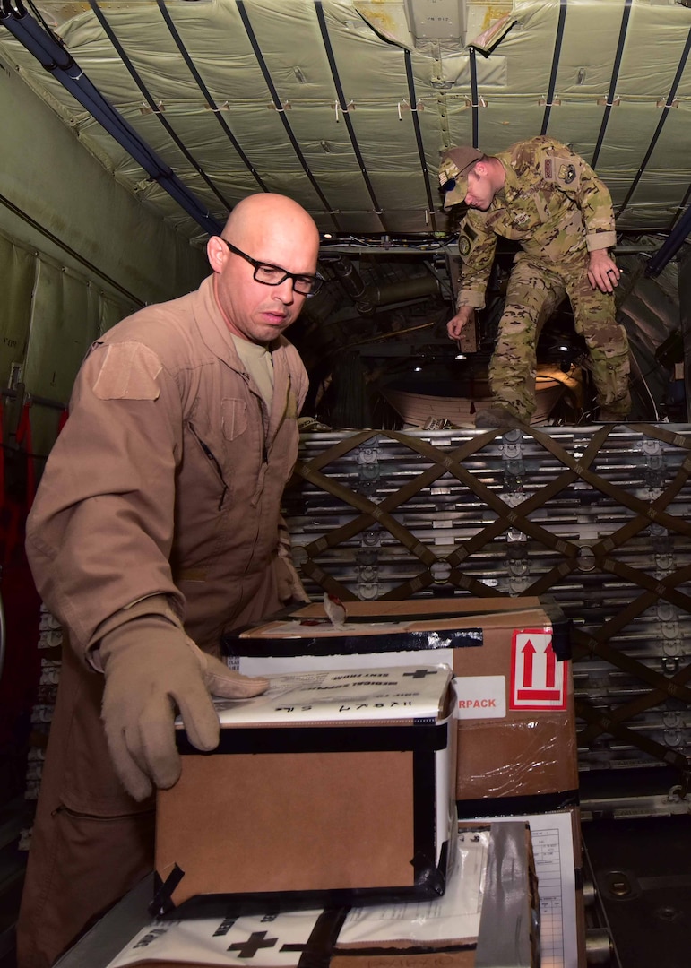 Master Sgt. Robbie Harrell (left) and Tech. Sgt. Michael Andrews, 737th Expeditionary Airlift Squadron loadmasters, prepare cargo for flight on a C-130 Hercules Oct. 10, 2017, in support of Operation Inherent Resolve at an undisclosed location in Southwest Asia.