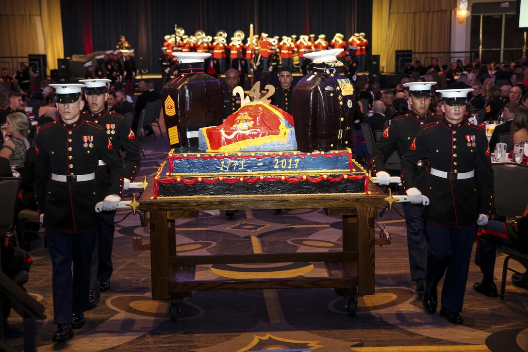 A cake cutting detail with Marine Barracks Washington D.C. marches with the traditional birthday cake during the Barrack’s Marine Corps Ball celebrating the Marine Corps’ 242nd birthday at the Washington Hilton, Washington D.C., Nov. 18, 2017. Each year, the Barracks holds a ball to honor and celebrate the Marine Corps’ birthday by reflecting on its rich traditions through the reading of Gen. John A. Lejeune’s birthday message and the cutting of the traditional birthday cake. (Official Marine Corps photo by Cpl. Damon Mclean/Released)