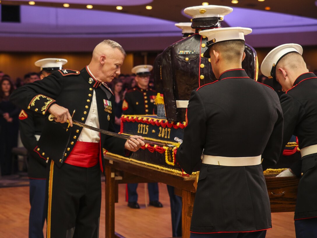 Colonel Tyler J. Zagurski, commanding officer, Marine Barracks Washington D.C., cuts the first piece of traditional cake during the Marine Barracks Washington’s Ball at the Washington Hilton, Washington D.C., Nov. 18, 2017. By tradition, the first piece of cake is given to the guest of honor and the second piece is given to oldest Marine present, who then passes it off to the youngest Marine which symbolizes the passing of knowledge and tradition to the newer generation of Marines.