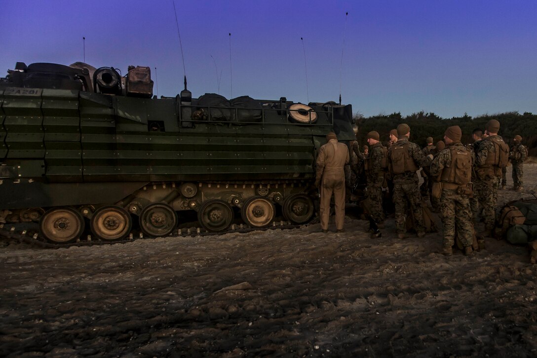 U.S. Marines with Fox Company, Battalion Landing Team, 2nd Battalion, 6th Marine Regiment, 26th Marine Expeditionary Unit (MEU), prepare to mount an AAV-P7/A1 assault amphibious vehicle at Onslow Beach, N.C., prior to returning to the dock landing ship USS Oak Hill (LSD 51) as part of the Combined Composite Training Unit Exercise, Nov. 20, 2017. Combined COMPTUEX serves as the capstone event for the Amphibious Ready Group-MEU team prior to a deployment, fully integrating the ARG-MEU team as an amphibious force and testing their ability to execute missions across a range of military operations. (U.S. Marine Corps photo by Staff Sgt. Dengrier M. Baez)