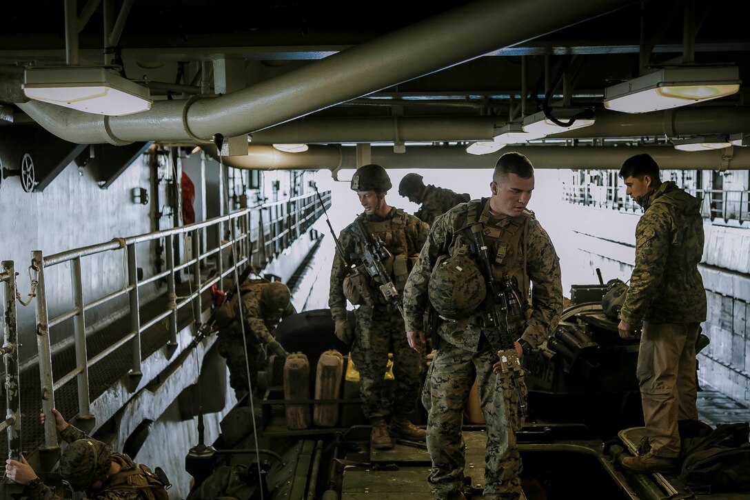 U.S. Marines with Fox Company, Battalion Landing Team, 2nd Battalion, 6th Marine Regiment, 26th Marine Expeditionary Unit (MEU), exit AAV-P7/A1 assault amphibious vehicles (AAV) at the well deck of the dock landing ship USS Oak Hill (LSD 51) after returning from a night mechanized raid at Camp Lejeune, N.C., during Combined Composite Training Unit Exercise, Nov. 20, 2017. Combined COMPTUEX serves as the capstone event for the Amphibious Ready Group-MEU team prior to a deployment, fully integrating the ARG-MEU team as an amphibious force and testing their ability to execute missions across a range of military operations. (U.S. Marine Corps photo by Staff Sgt. Dengrier M. Baez)