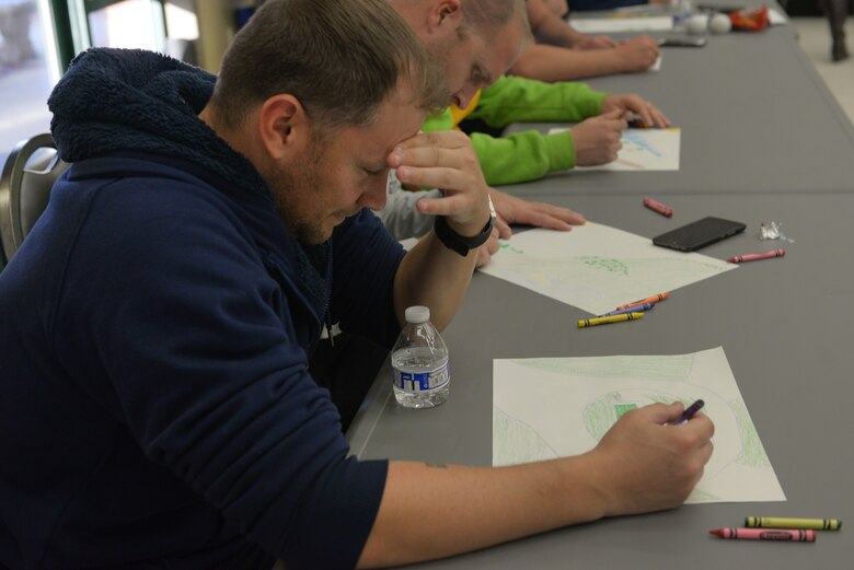 Tech Sgt. Christopher Khalaf, shift supervisor for the 437th Aircraft Maintenance Squadron, analyzes the road he drew during the art therapy portion of the 360 Leaders Course held at JB Charleston November 13-17, 2017. The 360 Course uses art therapy to help students express their past and what they want to achieve in the future.