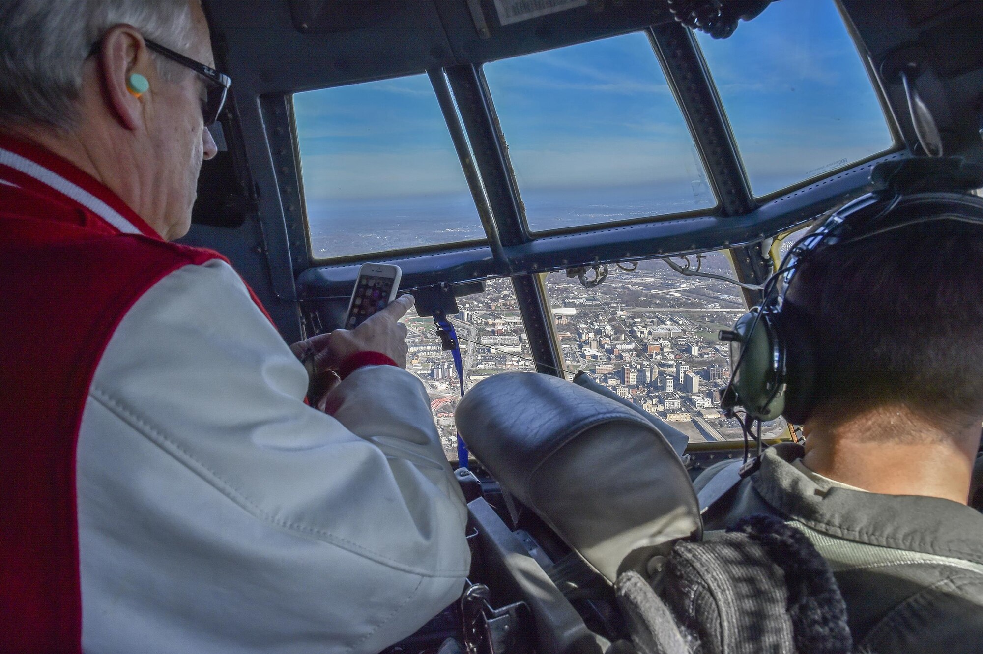 Youngstown State University President Jim Tressel, also the honorary commander of the 910th Airlift Wing, views downtown Youngstown and Youngstown State University from the flight deck of a 910th C-130H Hercules aircraft, Nov. 20, 2017.