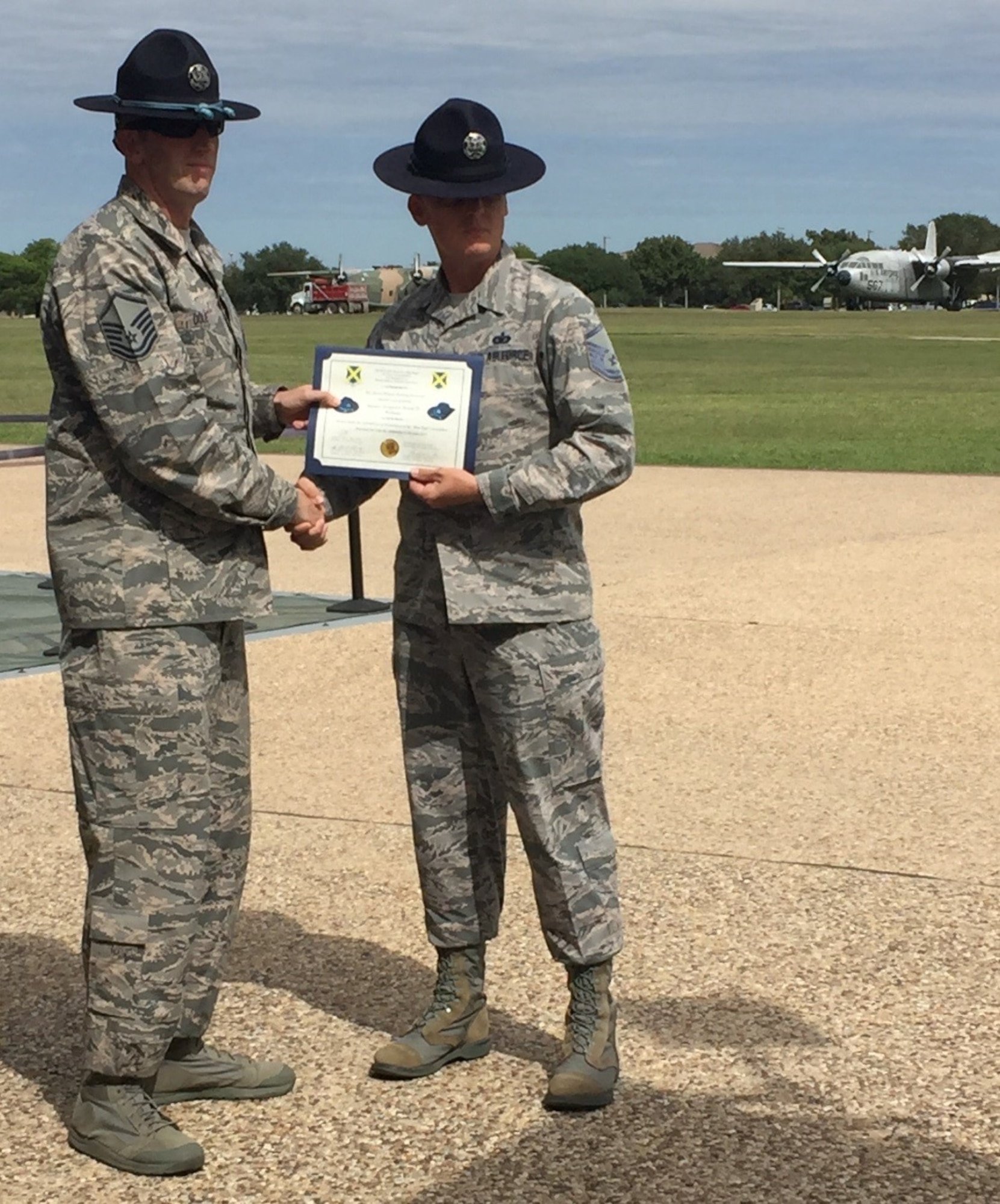 Master Sgt. Joseph Dole (left), 331st Training Squadron, Joint Base San Antonio-Lackland, Texas, Blue Rope Association president, presents Master Sgt. Jason Wagner, 433rd Training Squadron, with a certificate recognizing his acceptance into the Master Military Instructor “Blue Rope” Association. (Air Force photo)