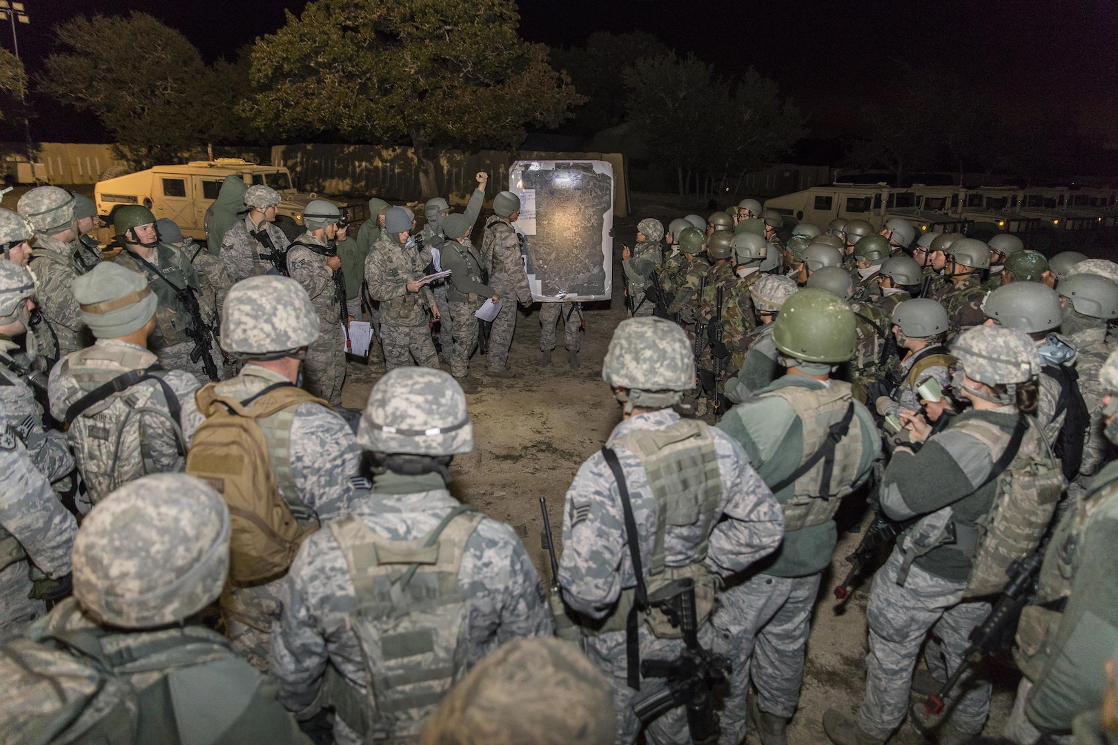 Students from the Inter-American Air Force Academy’s 837th Training Squadron and 343rd TRS attend a pre-mission briefing at Joint Base San Antonio-Camp Bullis as part of their final training exercise Nov. 8, 2017. The students practiced reconnaissance, ambush, searching, and patrolling tactics. This was the first time the 837th TRS and 343rd TRS partnered for joint training.