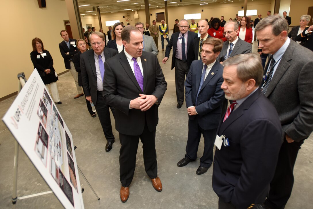 Dale Christianson (Purple tie), federal project officer for the Uranium Project Facility Project Office, briefs dignitaries at the dedication of the new Construction Support Building Nov. 20, 2017 at the Y-12 National Security Complex in Oak Ridge, Tenn.  The three-story, 64,800-square-foot building will provide a combination of office and warehouse space and is the first permanent structure constructed as part of the Uranium Processing Facility project. The building will be LEED Gold Certified, which stands for Leadership in Energy and Environmental Design.  The building is resource-efficient and will have decreased utility costs. (USACE Photo by Lee Roberts)